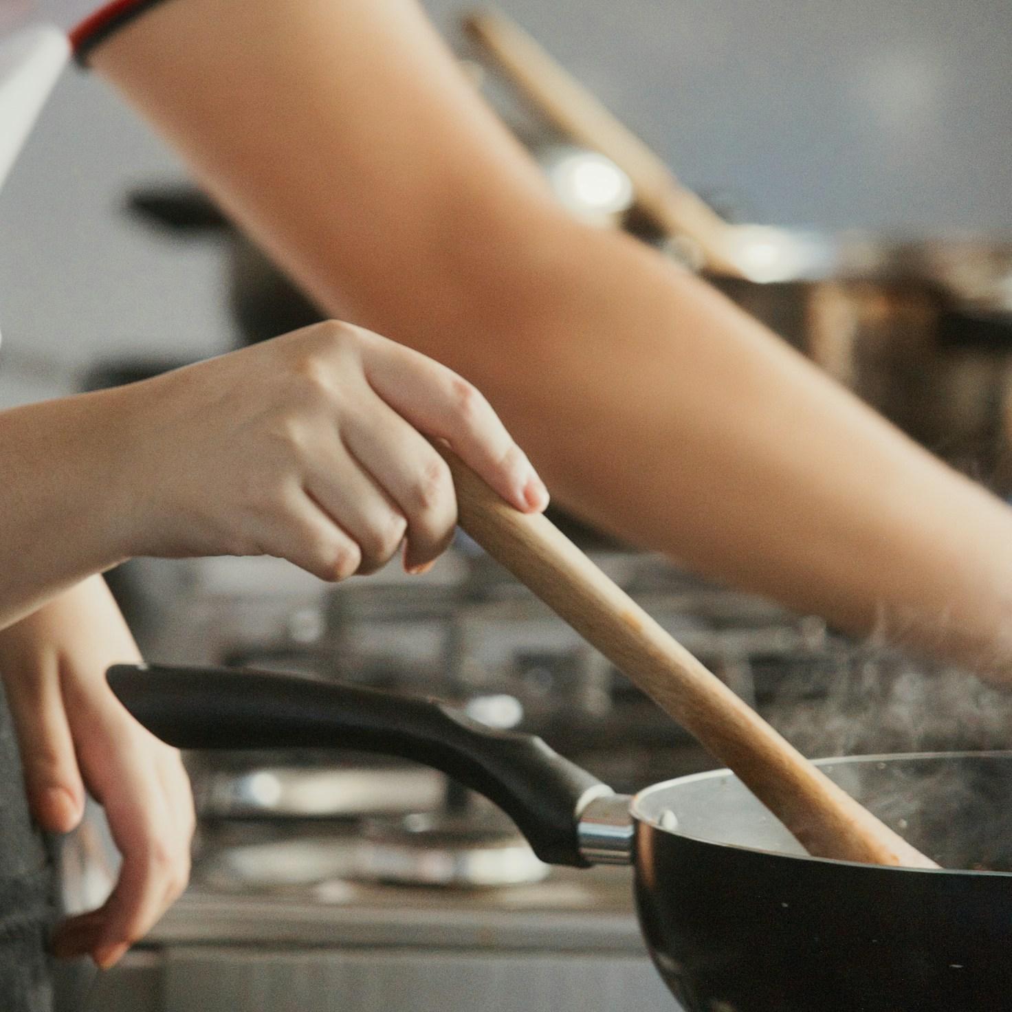 Community members collaborating in a modern kitchen space, sharing recipes and cooking techniques